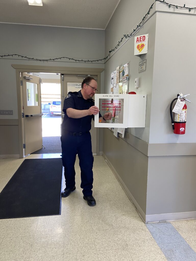 AED instructor opening the AED cabinet